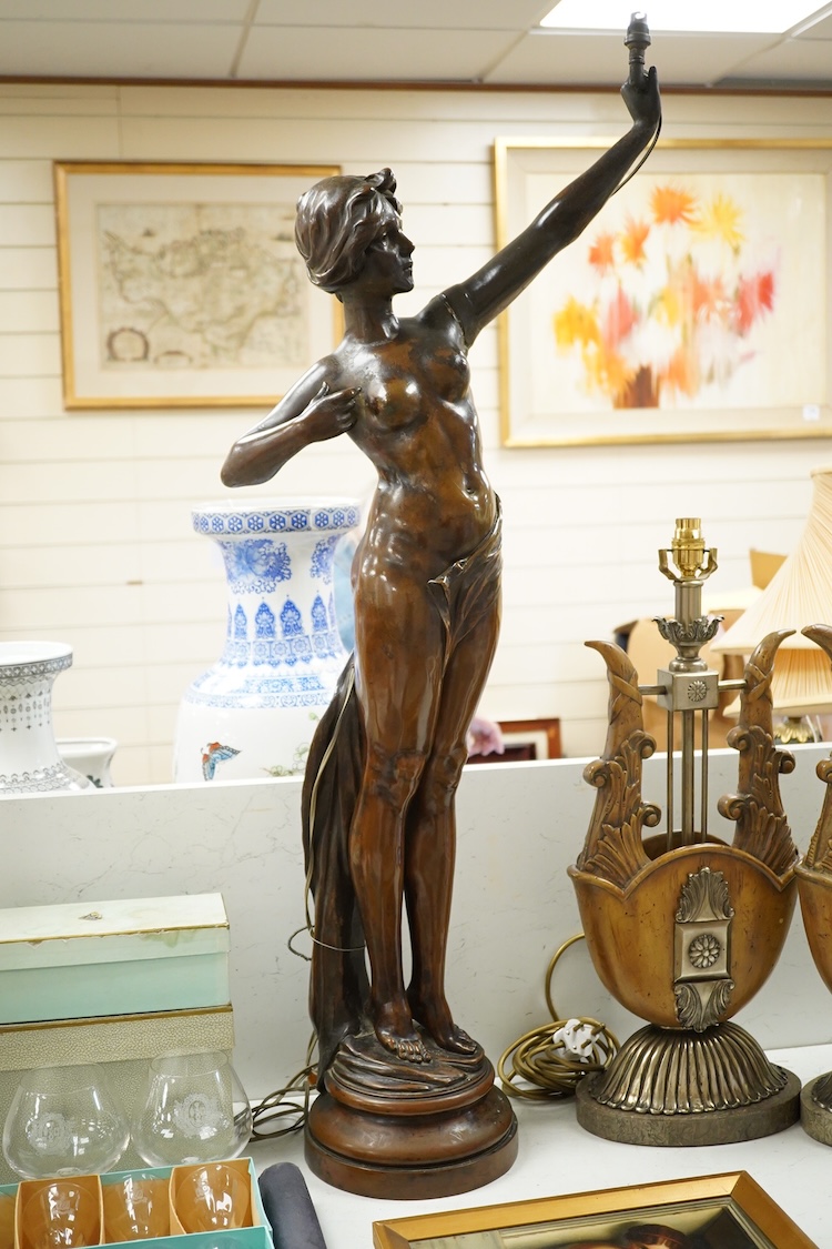 A large bronzed composition figurine of a lady, converted to an electric lamp, 104cm high